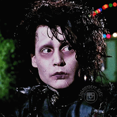 a close up of a person 's face with johnnydepp gifs written around his neck