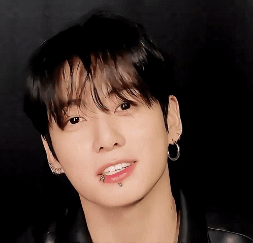 a close up of a person 's face with piercings