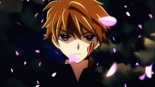 A Close Up Of A Person 'S Face With Pink Petals Falling Around Him GIF