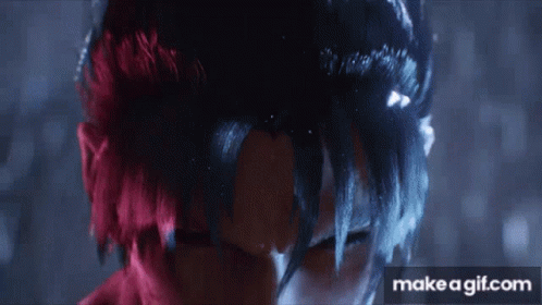 A Close Up Of A Person 'S Face With Red And Black Hair . GIF