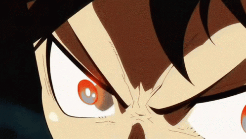 A Close Up Of A Person 'S Face With Red Eyes And A Black Background GIF