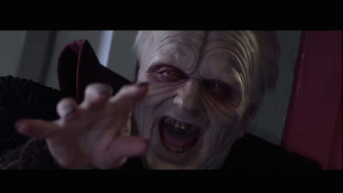A Close Up Of A Person 'S Face With Red Eyes And Gray Hair GIF