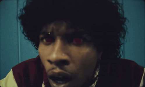 A Close Up Of A Person 'S Face With Red Eyes GIF