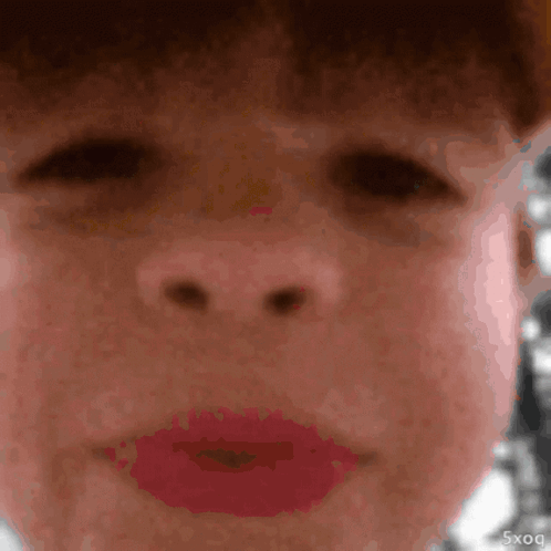 A Close Up Of A Person 'S Face With Red Lipstick And The Letters 5Xq On The Bottom Right GIF
