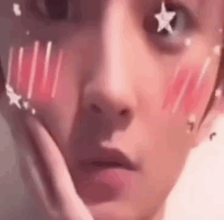 A Close Up Of A Person 'S Face With Stars On It And A Hand On Their Face . GIF