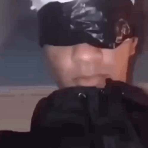 A Close Up Of A Person 'S Face With Tape On It . GIF