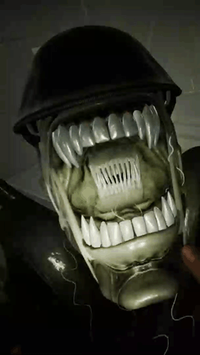 A Close Up Of A Person 'S Face With Teeth And A Helmet On It GIF
