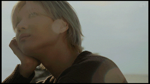 A Close Up Of A Person 'S Face With The Letters Sm On The Bottom Right GIF