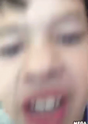 A Close Up Of A Person 'S Face With The Word Mega On The Bottom Right GIF