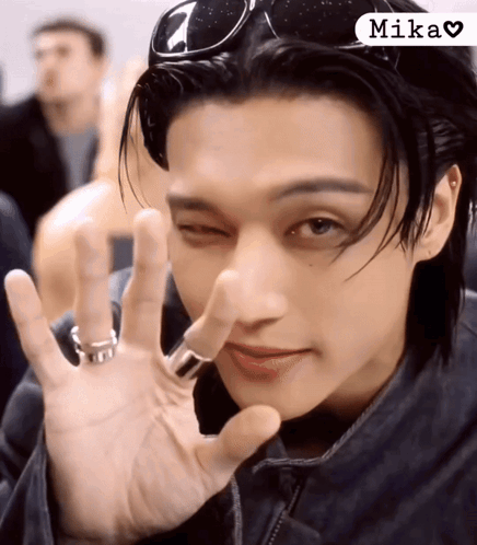 A Close Up Of A Person 'S Face With The Word Mika On The Bottom Right GIF