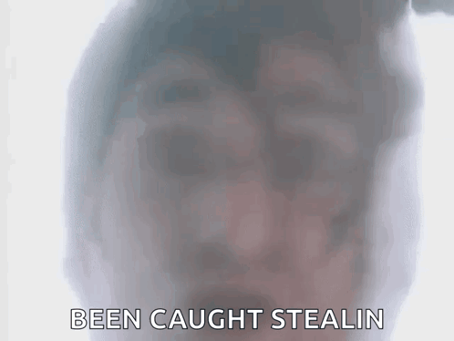 A Close Up Of A Person 'S Face With The Words Been Caught Stealin Written Below It . GIF