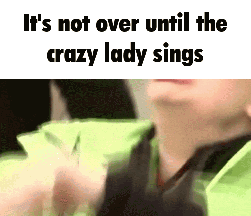 A Close Up Of A Person 'S Face With The Words `` It 'S Not Over Until The Crazy Lady Sings '' Above It . GIF