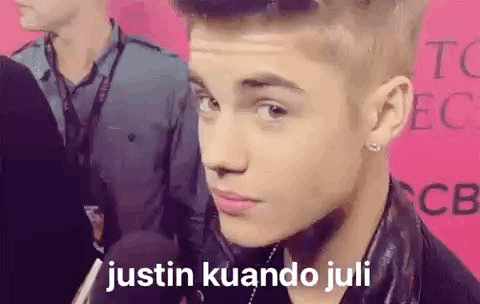 A Close Up Of A Person 'S Face With The Words `` Justin Kuando Juli '' Written On The Bottom . GIF