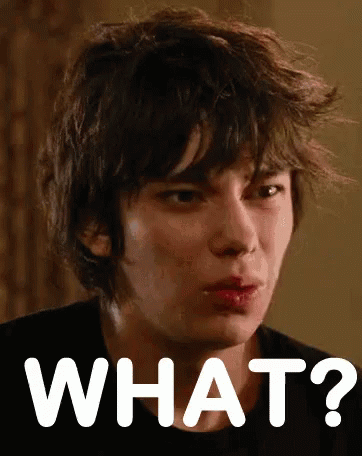 A Close Up Of A Person 'S Face With The Words What Written In White GIF