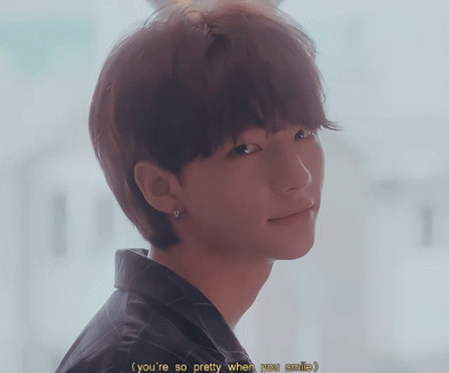 a close up of a person 's face with the words " you 're so pretty when you smile "