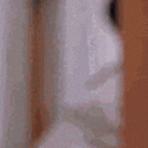 A Close Up Of A Person 'S Face With Their Eyes Closed And A Blurred Background . GIF