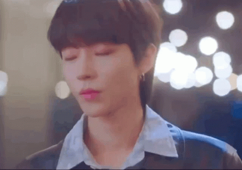A Close Up Of A Person 'S Face With Their Eyes Closed And A Blurry Background . GIF
