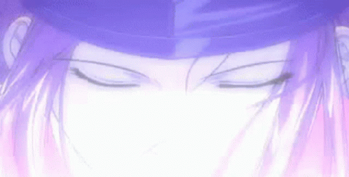 A Close Up Of A Person 'S Face With Their Eyes Closed And A Purple Hat On . GIF