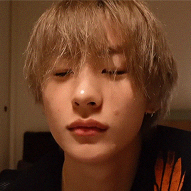 a close up of a person 's face with their eyes closed and blonde hair