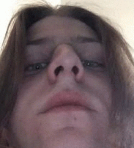 A Close Up Of A Person 'S Face With Their Eyes Closed And Their Nose Visible . GIF