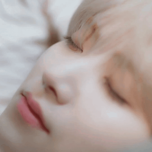 A Close Up Of A Person 'S Face With Their Eyes Closed . GIF