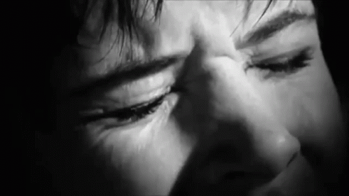 A Close Up Of A Person 'S Face With Their Eyes Closed . GIF