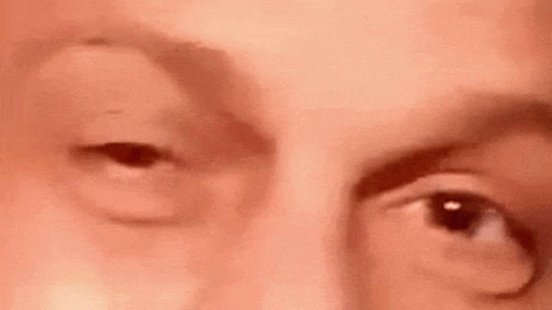 A Close Up Of A Person 'S Face With Their Eyes Open . GIF