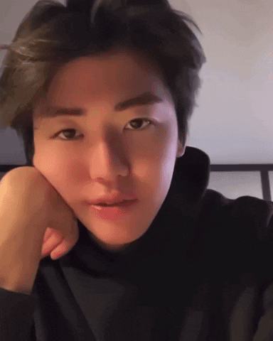 A Close Up Of A Person 'S Face With Their Hand On Their Face . GIF