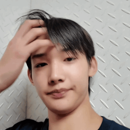 A Close Up Of A Person 'S Face With Their Hand On Their Forehead GIF