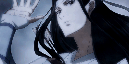 A Close Up Of A Person 'S Face With Their Hand Outstretched GIF