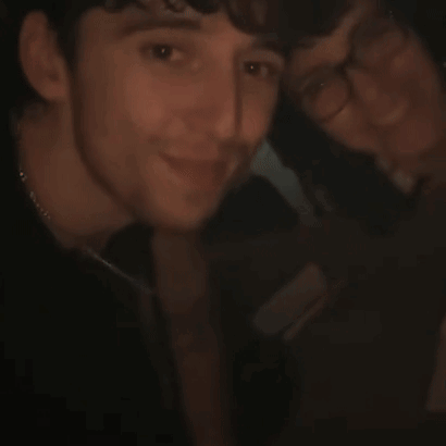 A Close Up Of A Person 'S Face With Their Hand Up GIF