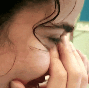 A Close Up Of A Person 'S Face With Their Hands On Their Face GIF