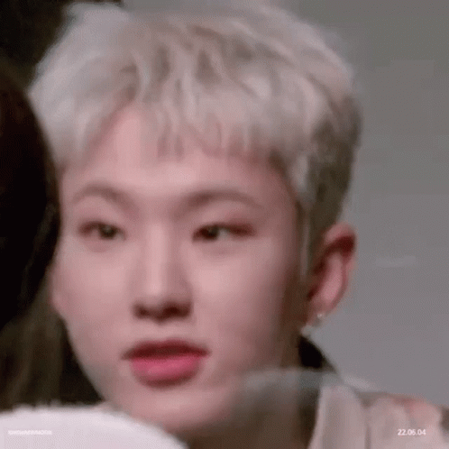 A Close Up Of A Person 'S Face With Their Mouth Open And A Person Behind Them . GIF