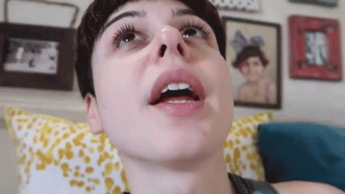 A Close Up Of A Person 'S Face With Their Mouth Open And Their Teeth Visible . GIF
