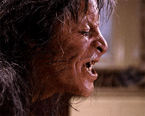A Close Up Of A Person 'S Face With Their Mouth Open And Wet Hair GIF
