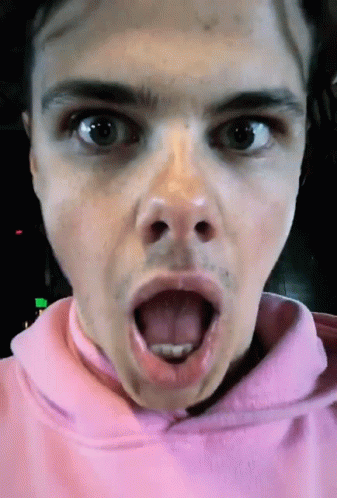 A Close Up Of A Person 'S Face With Their Tongue Out GIF