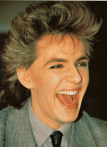 A Close Up Of A Person 'S Face With Their Tongue Sticking Out GIF
