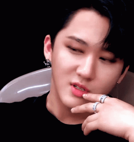 A Close Up Of A Person 'S Face With Two Rings On Their Finger GIF