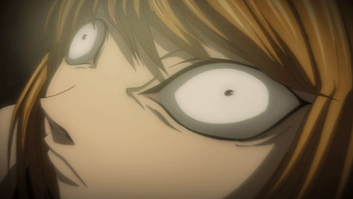 a close up of a person 's face with white eyes and a black spot in the middle