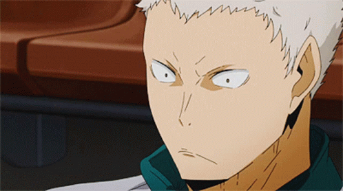 A Close Up Of A Person 'S Face With White Hair And A Green Shirt GIF
