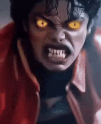 A Close Up Of A Person 'S Face With Yellow Eyes And Teeth GIF