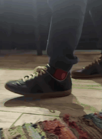 A Close Up Of A Person 'S Feet Wearing Black Shoes GIF
