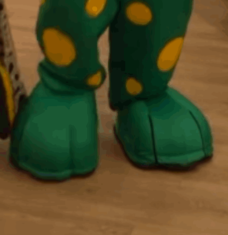 A Close Up Of A Person 'S Feet Wearing Green And Yellow Polka Dot Boots GIF