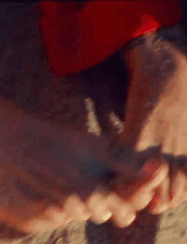 A Close Up Of A Person 'S Feet With Red Nail Polish On Them GIF