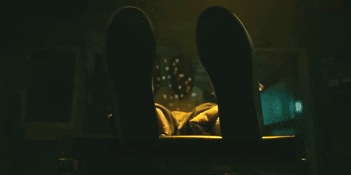 A Close Up Of A Person 'S Fist With A Yellow Light Behind It GIF