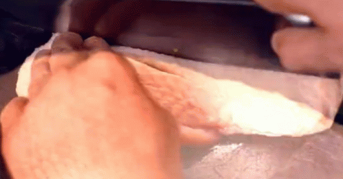 a close up of a person 's foot being wiped with a napkin .
