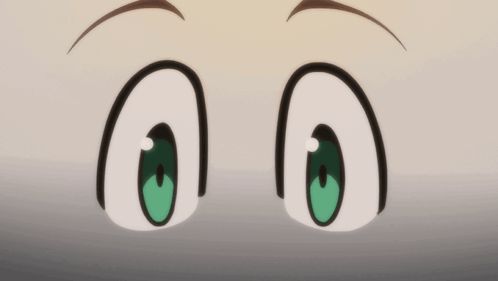 a close up of a person 's green eyes