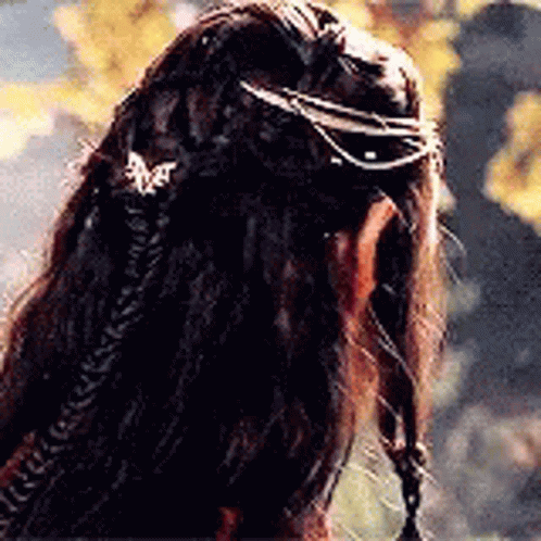 A Close Up Of A Person 'S Hair With A Braid And A Ring On It . GIF