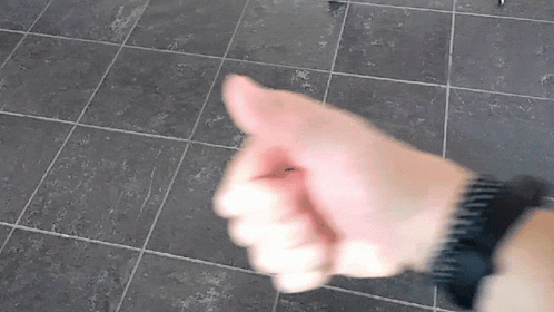 A Close Up Of A Person 'S Hand Giving A Thumbs Up Sign GIF