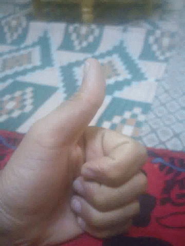 A Close Up Of A Person 'S Hand Giving The Thumbs Up GIF